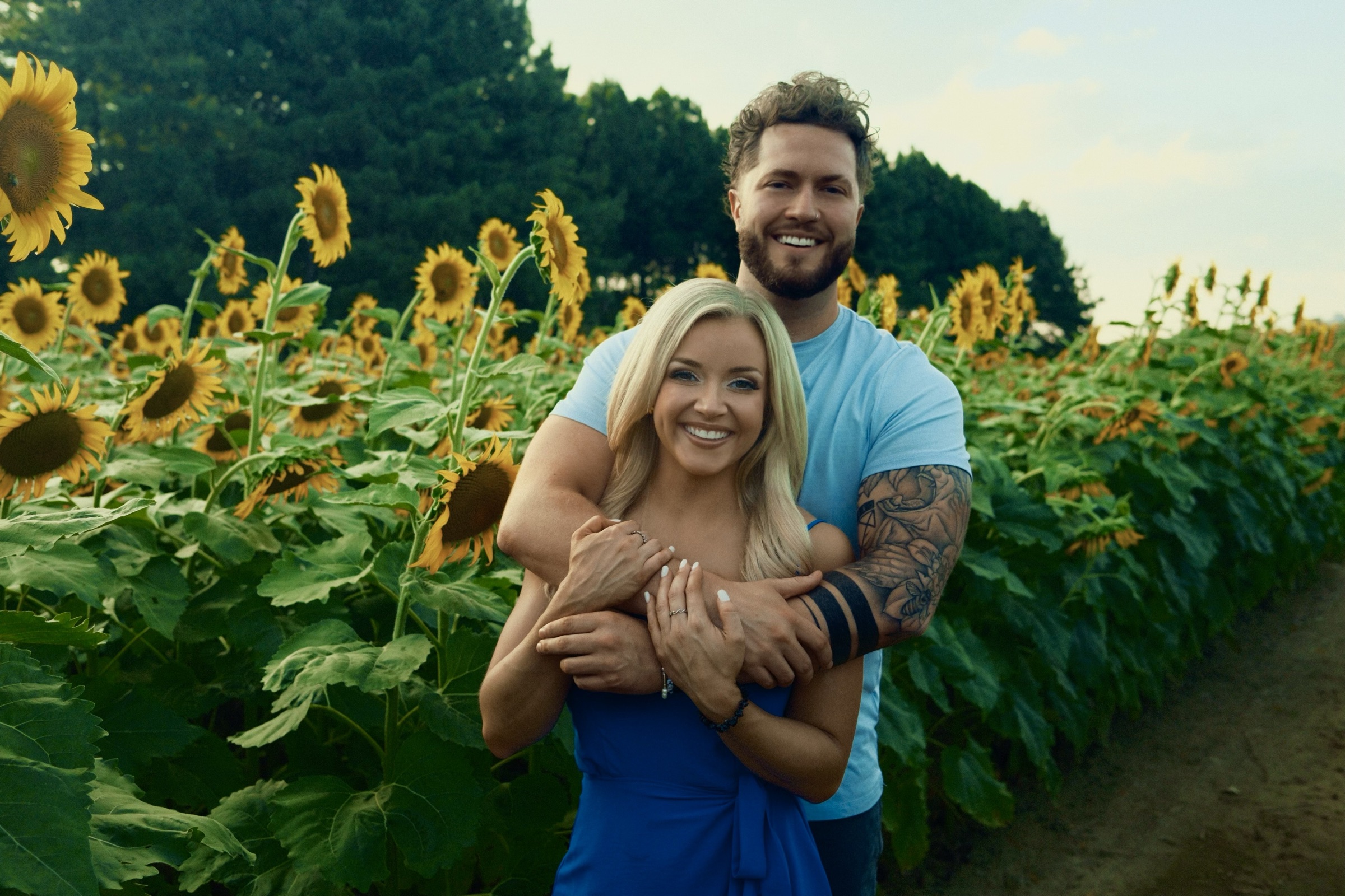 Phil and Sarah in a field of sunflowers.